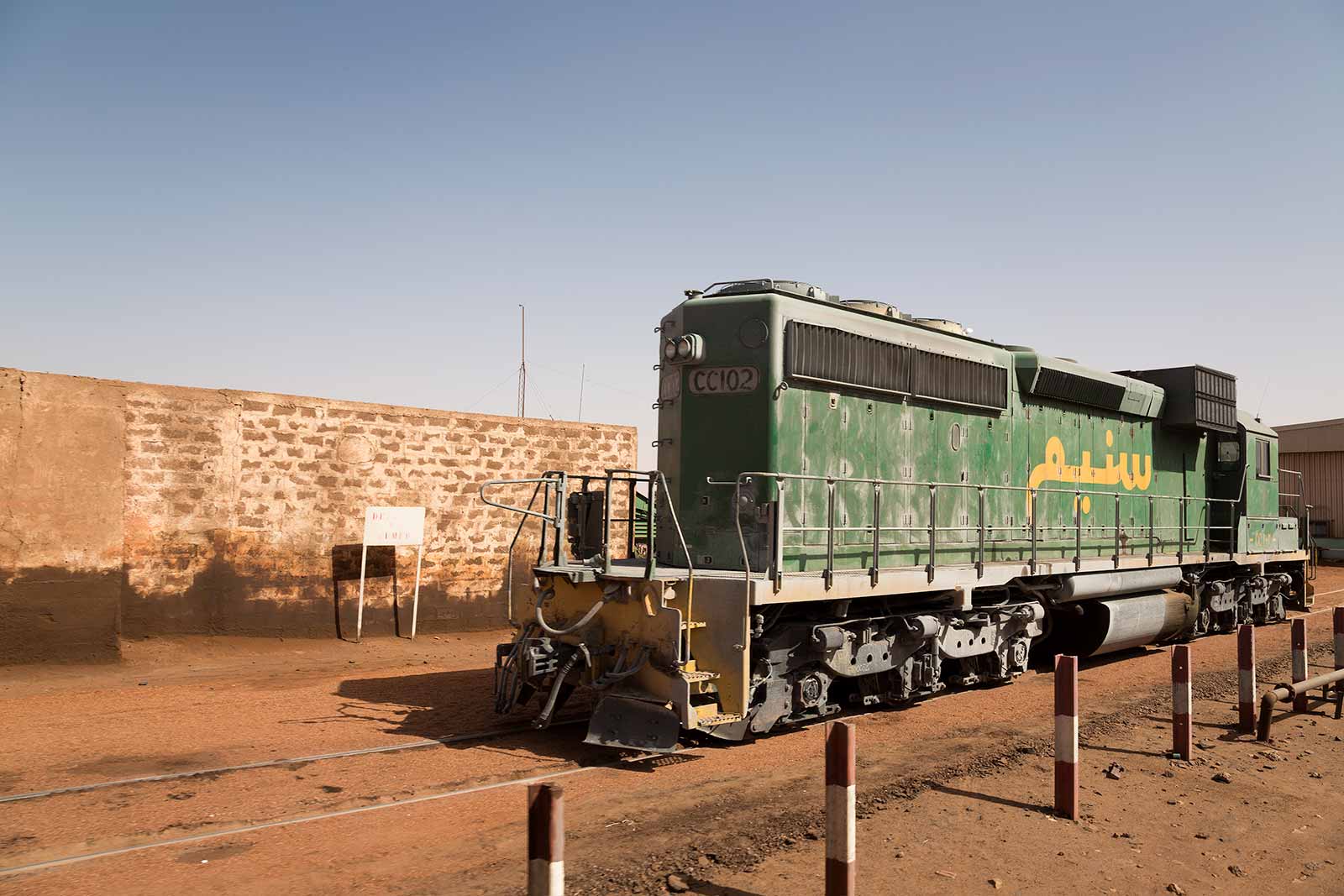 The bulk cargo train travels from the Sahara desert to the coast through dry nowhere to transport valuable minerals across Mauritania.