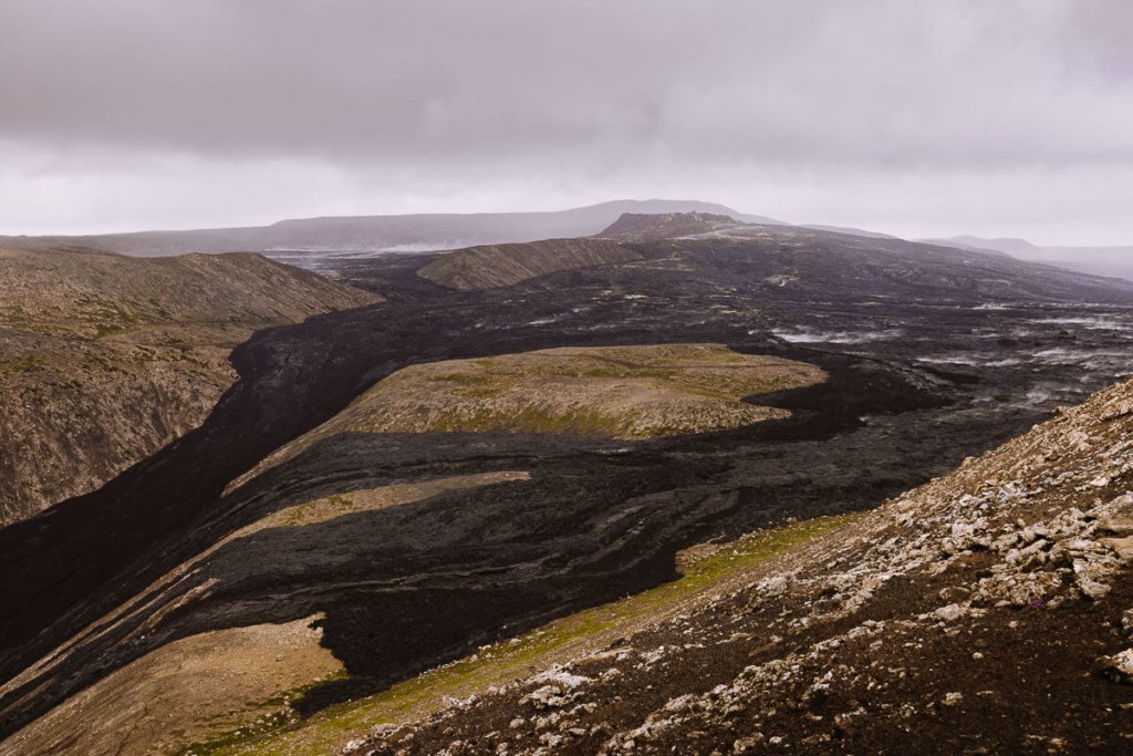 lava flowing down either side of the mountain at Fagradalsfjall Volcano, Iceland
