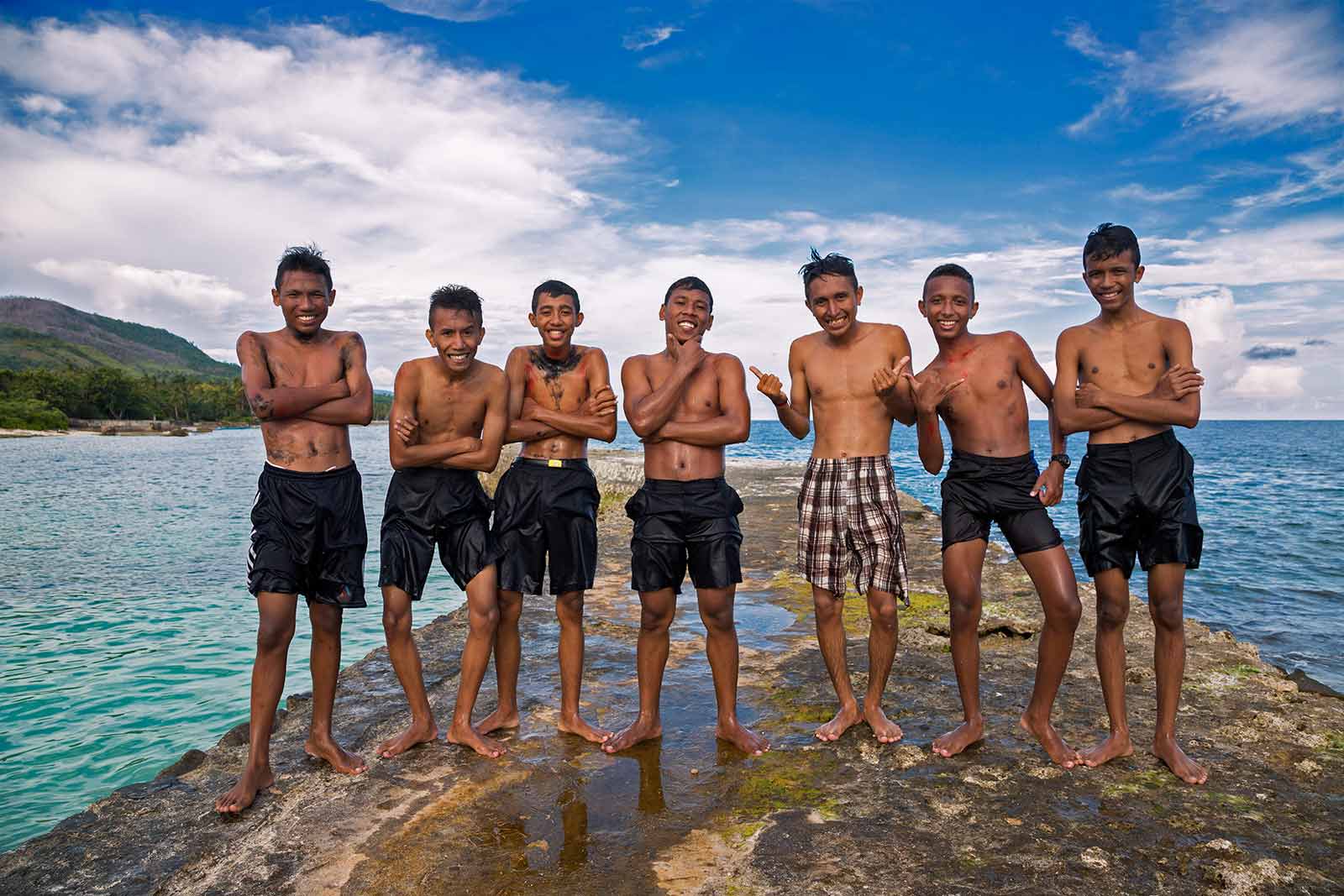 Maluku Islands: Tourists are a rare sight in Ambon, especially with the kind of camera gear we use, so these boys immediately started posing for us.