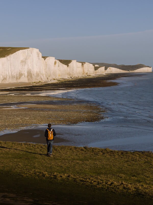 Walking in front of the dramatic white cliffs of the Seven Sisters