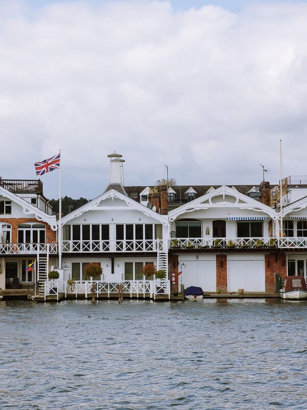 Boat houses on the Thames River walk near London