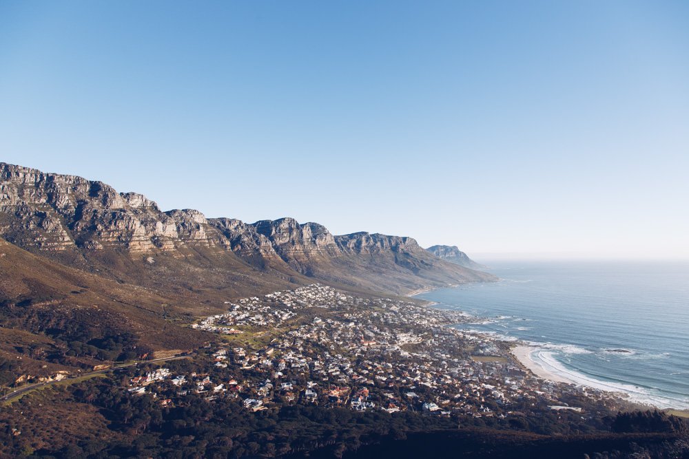 The sweeping coastline of Cape Town backed by rugged mountains.