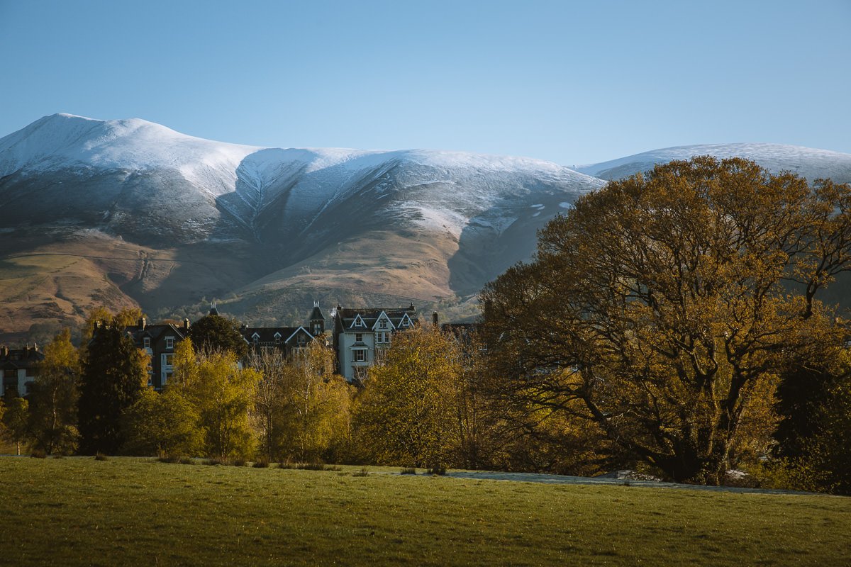 Terrace houses in Keswick framed by snow capped mountains