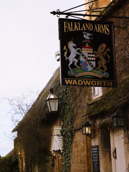 Sign saying "Falkland Arms Wadworth" outside small old pub