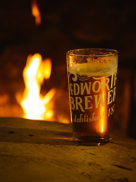 Pint of beer in front of a roaring fire, Falkland Arms, Great Tew